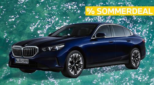 Ein dunkelblauer BMW 520i Limousine steht vor einem türkisfarbenen, leicht unruhigen Wasserhintergrund. Das Auto ist leicht nach links vorne ausgerichtet, sodass die Front und die linke Seite gut sichtbar sind. Oben rechts im Bild befindet sich ein gelbes Banner mit der Aufschrift „% SOMMERDEAL“ in Großbuchstaben. Das Fahrzeug hat glänzende, mehrspeichige Felgen und eine moderne, elegante Linienführung.